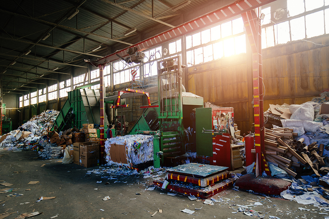 Floor littered with packaging debris in a recycling factory