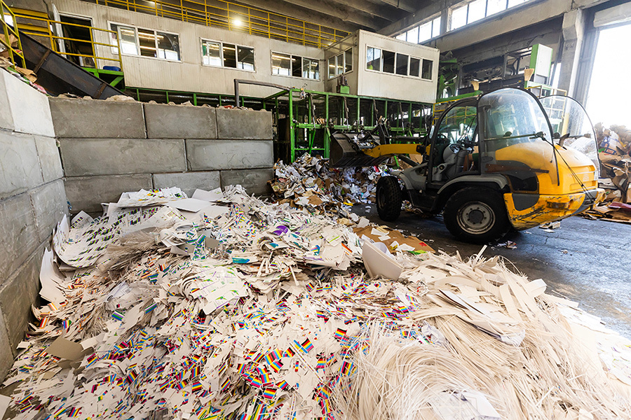Large pile of paper debris in a waste sorting facility
